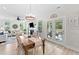 Open-concept dining area with a decorative chandelier, wood floors, and patio access at 1004 Saltwater Cir, Johns Island, SC 29455