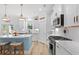 Modern white kitchen featuring stainless steel appliances, quartz countertops, and herringbone backsplash at 1004 Saltwater Cir, Johns Island, SC 29455