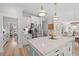 Bright, white kitchen featuring stainless steel appliances, an island with seating, and modern pendant lighting at 1004 Saltwater Cir, Johns Island, SC 29455