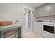 Well-organized laundry room with modern washer and dryer, storage cabinets, and a folding table at 1004 Saltwater Cir, Johns Island, SC 29455