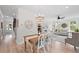 Open-concept living and dining area with chandelier, wood floors, and white furnishings at 1004 Saltwater Cir, Johns Island, SC 29455