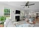 Bright and open living room with fireplace, large windows, and a comfortable sofa at 1004 Saltwater Cir, Johns Island, SC 29455