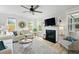 Bright and open living room with fireplace, large windows, and a comfortable sofa at 1004 Saltwater Cir, Johns Island, SC 29455