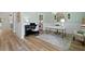 Bright office with stylish desk, piano, chandelier, and calming sage green walls at 1004 Saltwater Cir, Johns Island, SC 29455