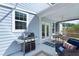 Covered outdoor patio with a grill, seating area, and screened-in enclosure offering a relaxing space at 1004 Saltwater Cir, Johns Island, SC 29455
