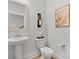 Neutral powder room with pedestal sink, toilet, and stylish decorations at 1004 Saltwater Cir, Johns Island, SC 29455