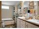 Bathroom featuring double sinks, drawers, and a vanity area and tub at 1051 Cooper Store Rd, Moncks Corner, SC 29461