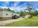 Long driveway leading to a single-story home, featuring ample parking space and a well-kept lawn, perfect for Gathering at 1051 Cooper Store Rd, Moncks Corner, SC 29461
