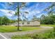 Charming single-story home surrounded by lush greenery, boasting a cozy front porch and well-maintained lawn at 1051 Cooper Store Rd, Moncks Corner, SC 29461