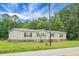 Inviting single-story home featuring a cozy front porch with white railings and a well-maintained lawn on a sunny day at 1051 Cooper Store Rd, Moncks Corner, SC 29461