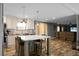 Bright kitchen boasts an island with counter seating and stainless steel appliances, flowing into the adjacent living area at 1051 Cooper Store Rd, Moncks Corner, SC 29461