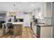 The kitchen features stainless appliances, white cabinetry, an island with seating, and light countertops at 1051 Cooper Store Rd, Moncks Corner, SC 29461