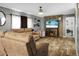 Comfortable living room features wood-look floors, ceiling fan, and entertainment center with fireplace at 1051 Cooper Store Rd, Moncks Corner, SC 29461