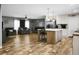 Open concept living room and kitchen area with wood-look floors and a kitchen island at 1051 Cooper Store Rd, Moncks Corner, SC 29461