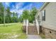 Side view showing a lovely brick stairway with decorative chairs, complemented by green lawn at 1051 Cooper Store Rd, Moncks Corner, SC 29461