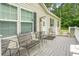 Inviting outdoor porch furnished with charming metal chairs, creating a cozy and relaxing space at 1051 Cooper Store Rd, Moncks Corner, SC 29461