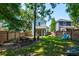 Spacious backyard with a screen porch, wooden picnic table, privacy fence and colorful Adirondack chairs at 1076 Hatfield St, North Charleston, SC 29405