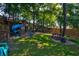 Backyard features a wooden playset with slides, privacy fence, bench, and a mixture of grass and mulched areas at 1076 Hatfield St, North Charleston, SC 29405