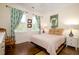 Charming bedroom with a ceiling fan, hardwood floors and large windows with curtains at 1076 Hatfield St, North Charleston, SC 29405