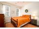 Bright bedroom with a ceiling fan, hardwood floors and large windows with blinds at 1076 Hatfield St, North Charleston, SC 29405