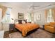 Bright bedroom with a ceiling fan, hardwood floors and large windows, and an orange bedspread at 1076 Hatfield St, North Charleston, SC 29405