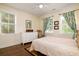 Bright bedroom with a ceiling fan, hardwood floors and large windows with curtains at 1076 Hatfield St, North Charleston, SC 29405