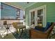 Inviting screened-in porch with comfortable seating, perfect for enjoying the outdoors in a relaxed setting at 1076 Hatfield St, North Charleston, SC 29405