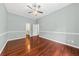 Large bedroom with hardwood floors, ceiling fan, and view of bathroom at 108 Woodlake Dr, Summerville, SC 29485