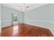 Spacious bedroom with ceiling fan, large window offering natural light, and hardwood floors at 108 Woodlake Dr, Summerville, SC 29485