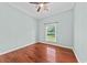 Cozy bedroom with hardwood floors, ceiling fan, and a large window overlooking the backyard at 108 Woodlake Dr, Summerville, SC 29485