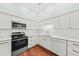 Modern kitchen features white cabinets, stainless steel appliances, and hardwood floors at 108 Woodlake Dr, Summerville, SC 29485