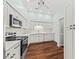 Well-lit kitchen featuring white cabinetry, stainless steel appliances, and dark hardwood floors at 108 Woodlake Dr, Summerville, SC 29485