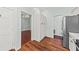 Spacious kitchen with wooden floors, white pantry cabinets, and stainless steel refrigerator at 108 Woodlake Dr, Summerville, SC 29485
