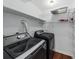 Laundry room with updated washer and dryer units and shelving at 108 Woodlake Dr, Summerville, SC 29485
