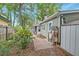 Exterior view of backyard featuring lush landscaping, storage shed and brick paver patio at 109 Willow Ct, Summerville, SC 29486