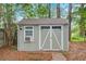 Outdoor storage shed, accessible by brick path, and accented by trimmed shrubs at 109 Willow Ct, Summerville, SC 29486