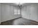 Bedroom featuring wood-look tile flooring, a modern chandelier, and natural light from the window at 109 Willow Ct, Summerville, SC 29486