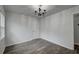 A clean bedroom with wood-look tile floors, a decorative chandelier, and neutral paint at 109 Willow Ct, Summerville, SC 29486