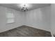 Bedroom with wood-look floors, chandelier, and large window creating a light-filled space at 109 Willow Ct, Summerville, SC 29486