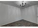 Neutral bedroom featuring wood-look tile floors, a decorative chandelier, and bright natural light at 109 Willow Ct, Summerville, SC 29486
