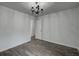 This bedroom showcases wood-look tile flooring, white walls, and a decorative chandelier at 109 Willow Ct, Summerville, SC 29486