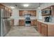 Well-lit kitchen featuring granite counters, stainless steel appliances, and ample wooden cabinetry at 109 Willow Ct, Summerville, SC 29486