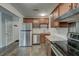 Kitchen with stainless steel appliances, granite counters, wooden cabinets, and wood-look tile flooring at 109 Willow Ct, Summerville, SC 29486