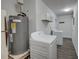 Laundry room featuring modern washing machine and dryer, along with a hot water heater at 109 Willow Ct, Summerville, SC 29486