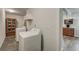 Bright laundry room with modern appliances and cabinets, adjacent to a kitchenette at 109 Willow Ct, Summerville, SC 29486