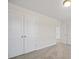 Bedroom featuring neutral carpet and white trim with view of entry and closet at 112 Shingle Oak Dr, Moncks Corner, SC 29461