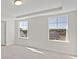 Bright bedroom with carpeted floors and large windows overlooking the neighborhood at 112 Shingle Oak Dr, Moncks Corner, SC 29461