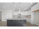 Open kitchen featuring hardwood floors, kitchen island, white cabinets, and natural light at 112 Shingle Oak Dr, Moncks Corner, SC 29461