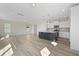 Open-concept living room and kitchen featuring light wood floors and abundant natural light at 112 Shingle Oak Dr, Moncks Corner, SC 29461