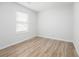 Bright bedroom featuring light-colored walls, wood floors and a window with blinds at 113 Alcester Rd, Goose Creek, SC 29445